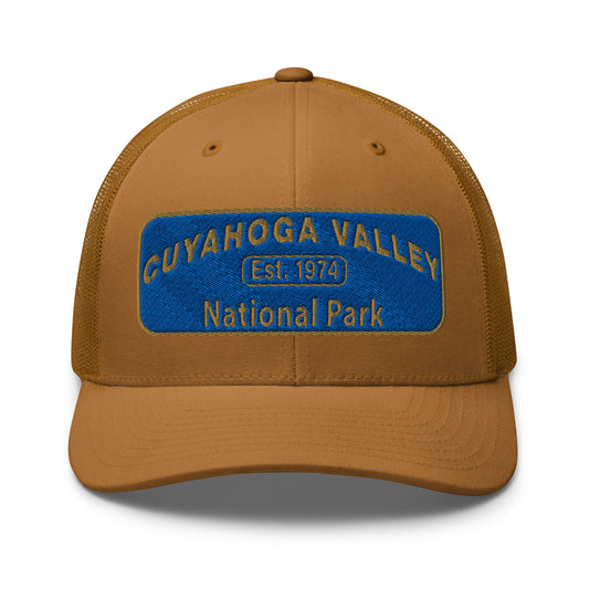 Cuyahoga Valley National Park Hat with a blue and gold embroidered park patch on the front on a Yupoong 6606 caramel trucker hat - front view.