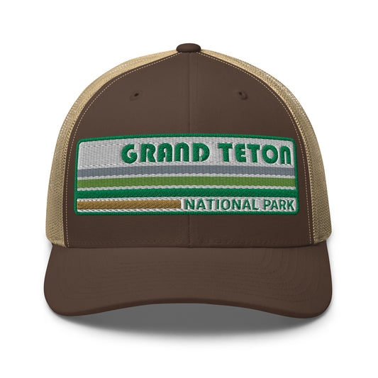 Grand Teton Hat with Retro 70's Style embroidered national park logo. Grand Teton National Park in Green on a Brown and Khaki Yupoong 6606 Trucker Hat Front side view.