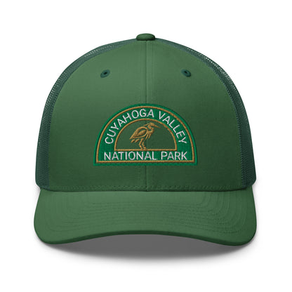 Cuyahoga Valley National Park Hat with a half moon embroiderd patch in Green and Sandstone featuring a Blue Heron on a Yupoong 6606 evergreen Hat - front view.