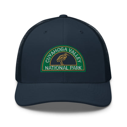 Cuyahoga Valley National Park Hat with a half moon embroiderd patch in Green and Sandstone featuring a Blue Heron on a Yupoong 6606 blue Hat - front view.