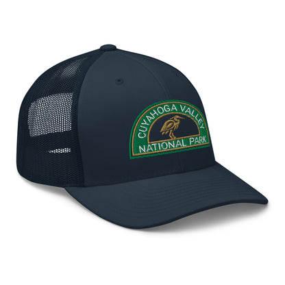 Cuyahoga Valley National Park Hat with a half moon embroiderd patch in Green and Sandstone featuring a Blue Heron on a Yupoong 6606 blue Hat - side view.