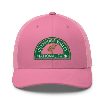 Cuyahoga Valley National Park Hat with a half moon embroiderd patch in Green and Sandstone featuring a Blue Heron on a Yupoong 6606 pink Hat - front view.