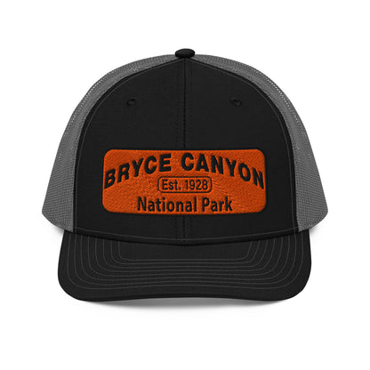 Bryce Canyon National Park Hat - Orange and Black Embroidered Patch - Richardson 112 Trucker Hat - Front View - Color:  Black/Charcoal