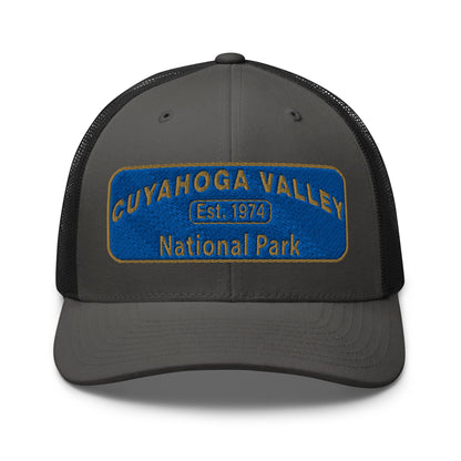 Cuyahoga Valley National Park Hat with a blue and gold embroidered park patch on the front on a Yupoong 6606 charcoal/black trucker hat - front view.