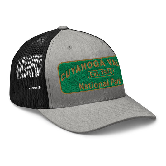 Cuyahoga National Park Hat with a green and gold embroidered national park styled patch on the front of a Yupoong 6606 heather grey/black trucker hat - side view.