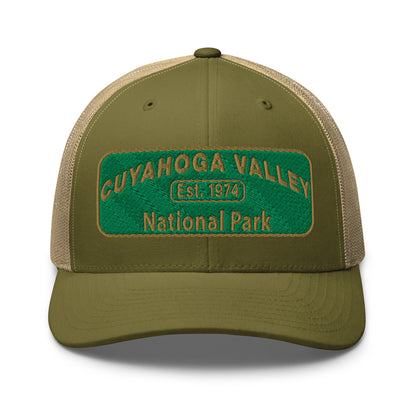 Cuyahoga National Park Hat with a green and gold embroidered national park styled patch on the front of a Yupoong 6606 moss green/khaki trucker hat - front view.