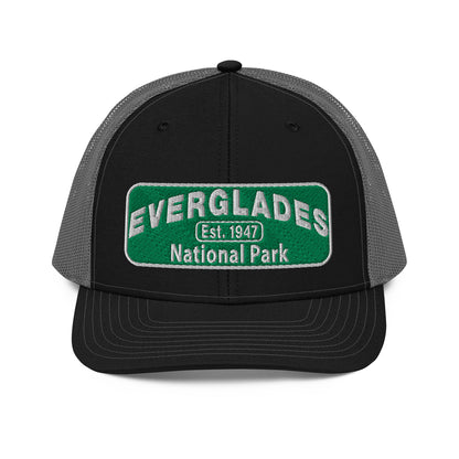 Everglades National Park Hat with a green and white embroidered park patch on a Black/Charcoal Richardson 112 trucker hat viewed from the front side.