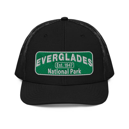Everglades National Park Hat with a green and white embroidered park patch on a Black Richardson 112 trucker hat viewed from the front side.