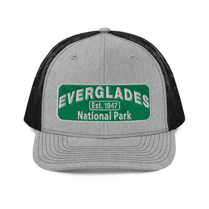 Everglades National Park Hat with a green and white embroidered park patch on a Heather/Black Richardson 112 trucker hat viewed from the front.