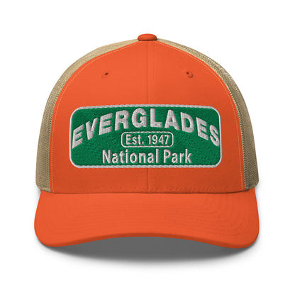 Everglades National Park Hat with a green and white embroidered national park patch on a orange/khaki Yupoong 6606 Trucker hat viewed from the front.