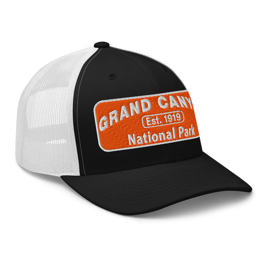 Black and white cap with orange and white text 'Grand Canyon National Park Est. 1919' on a white background