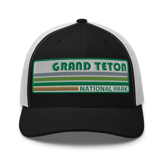 Grand Teton Hat with Retro 70's Style embroidered national park logo. Grand Teton National Park in Green on a Black and White Yupoong 6606 Trucker Hat front side view.