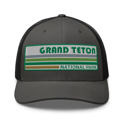Grand Teton Hat with Retro 70's Style embroidered national park logo. Grand Teton National Park in Green on a charcoal/black Yupoong 6606 Trucker Hat front side view.