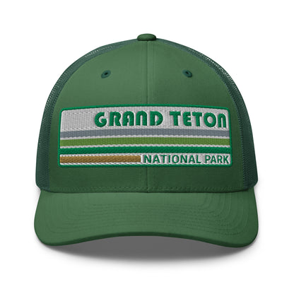 Grand Teton Hat with Retro 70's Style embroidered national park logo. Grand Teton National Park in Green on a green Yupoong 6606 Trucker Hat front side view.