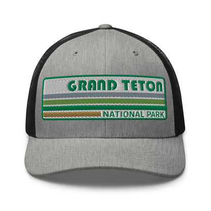 Grand Teton Hat with Retro 70's Style embroidered national park logo. Grand Teton National Park in Green on a heather/black Yupoong 6606 Trucker Hat front side view.