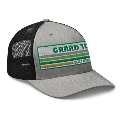 Grand Teton Hat with Retro 70's Style embroidered national park logo. Grand Teton National Park in Green on a heather/black Yupoong 6606 Trucker Hat right side view.